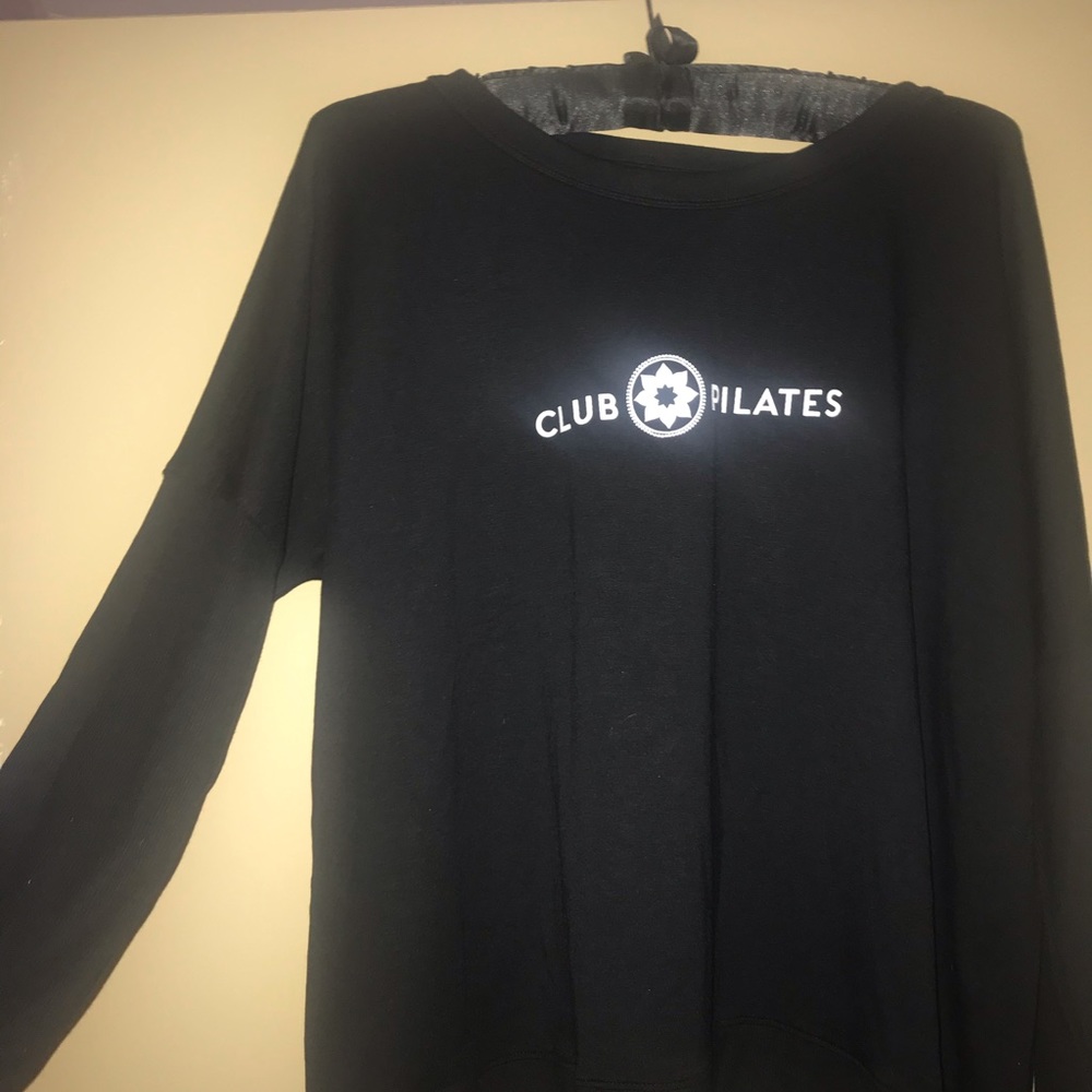 Club Pilates long sleeve sweater. Open back.